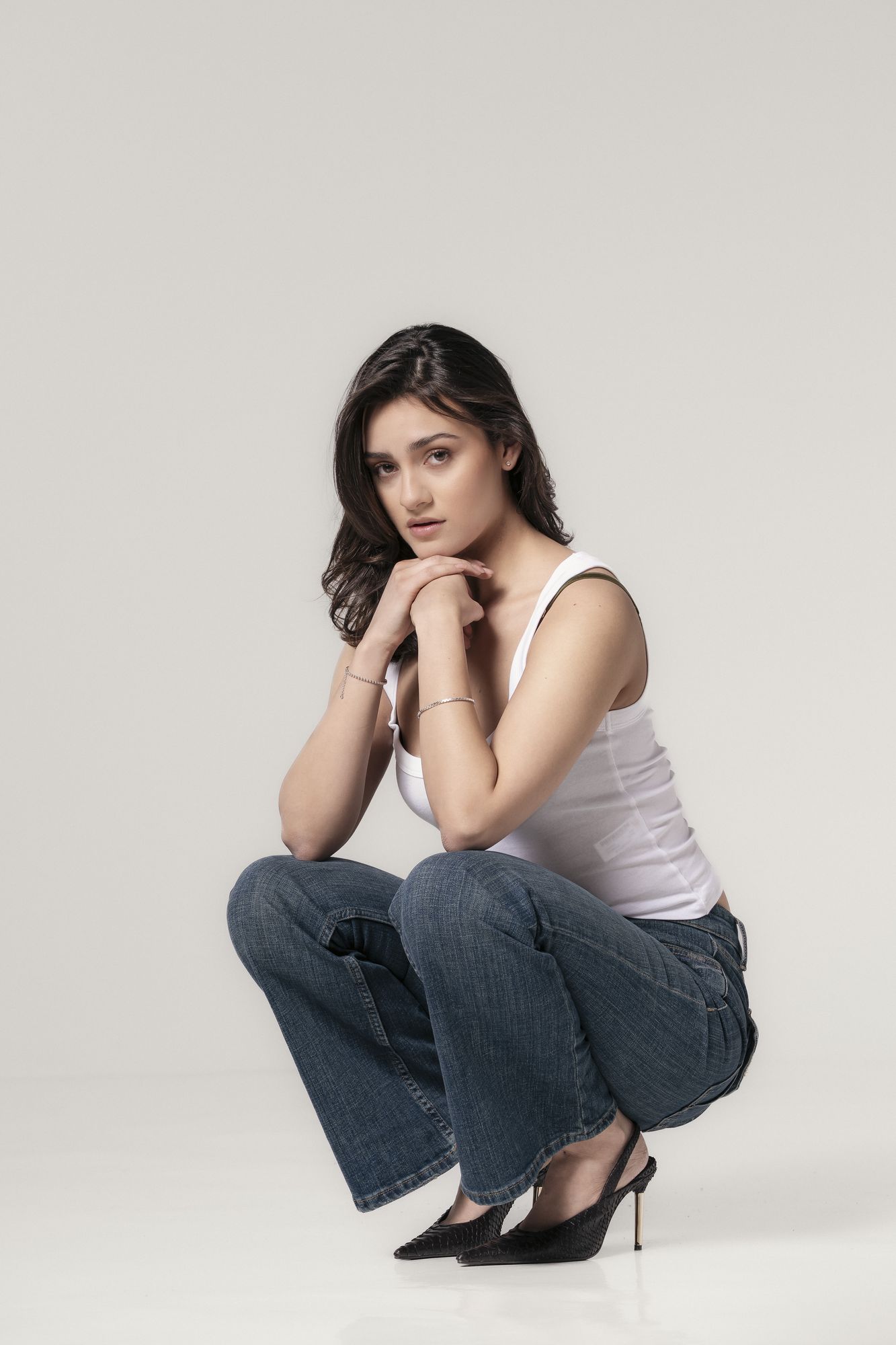 Casting portrait in jeans against a plain backdrop