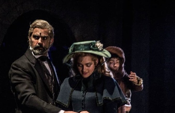 Lina de la Peña as Cosette in Les Misérables, on stage with Jean Valjean