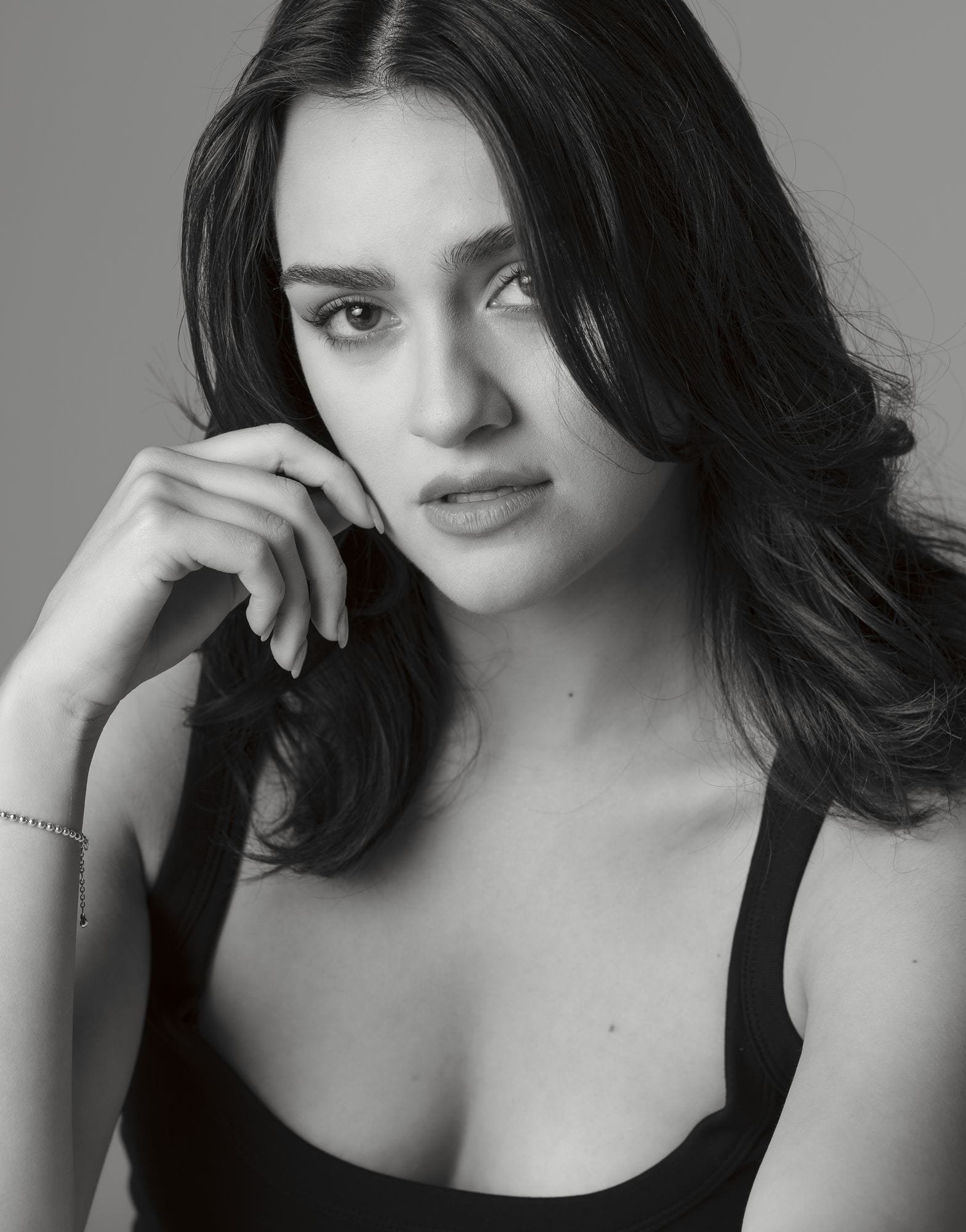 Black and white headshot, chin resting on one hand